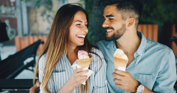 Happy Young Couple Having Date And Eating Ice Cream